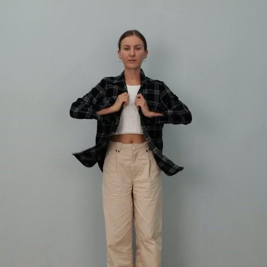 Adult participant adjusting her jacket in a controlled studio task